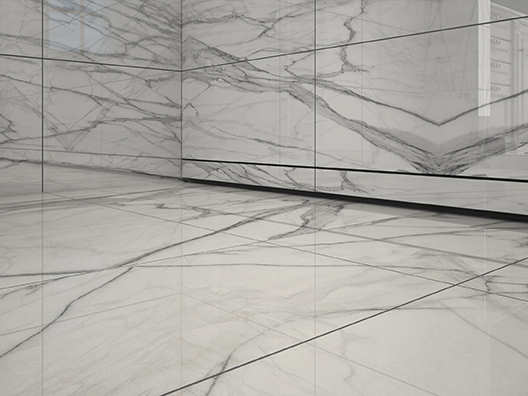 A QuickDrain WallDrain inside a marble shower